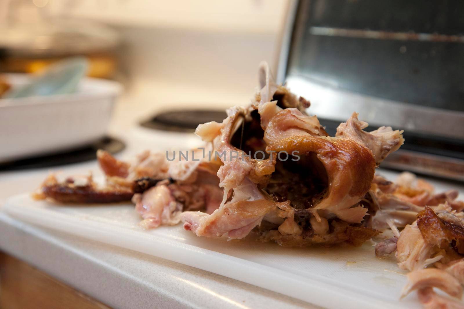 Delicious looking chicken meat on the body of a cooked or barbequed chicken 