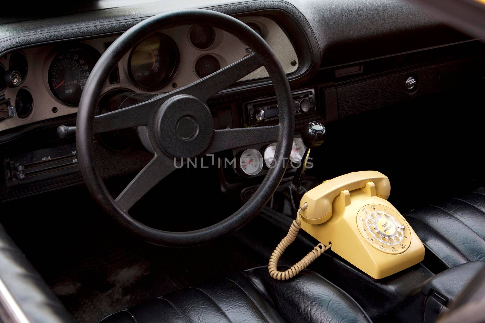  An old rotary telephone inside an antique car
