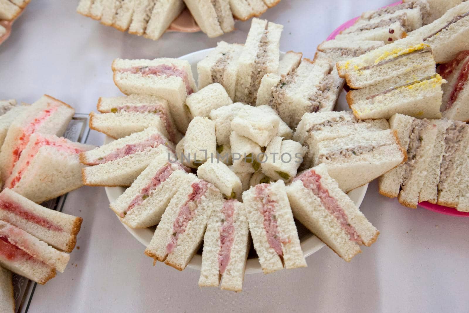 Tray of asparagus and ham sandwiches at a party or event 