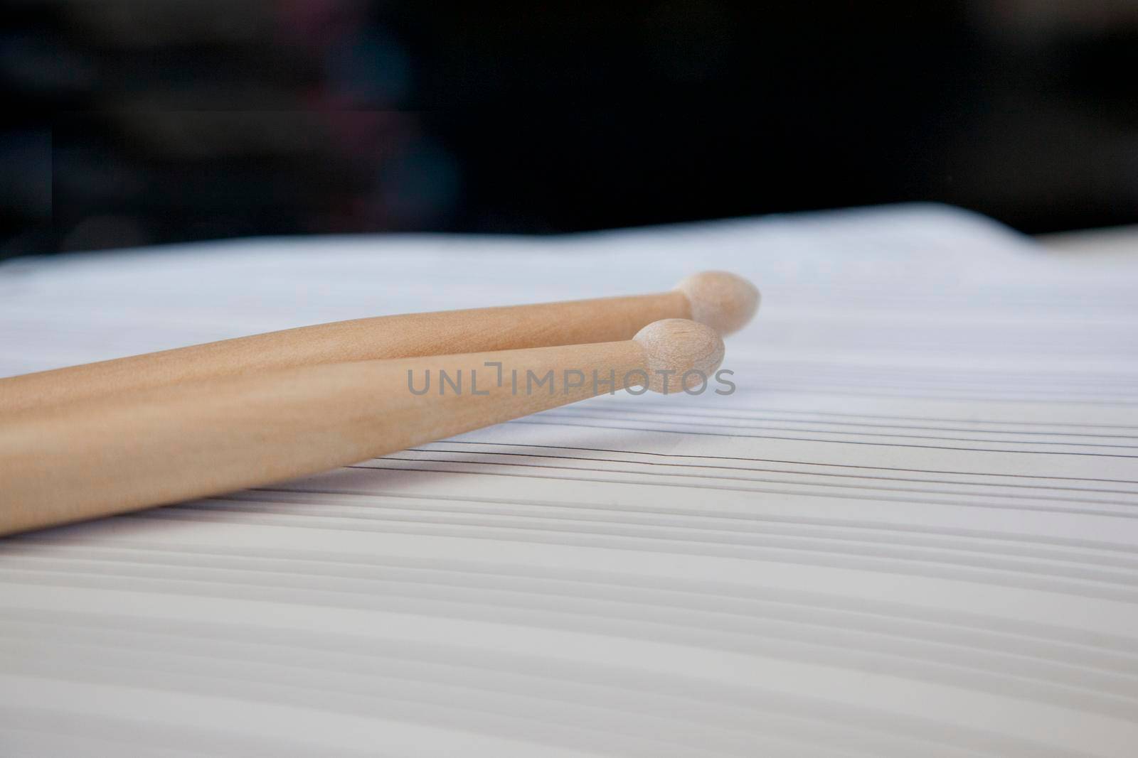  Blank sheet music with two wooden drum sticks 