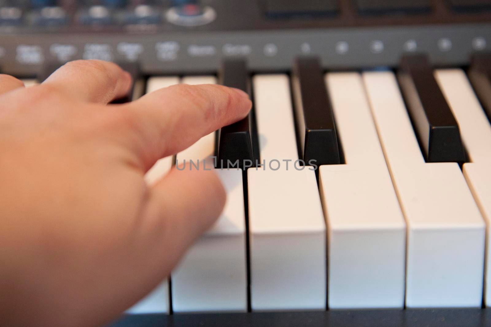  Fingers playing on a digital media keyboard or piano 