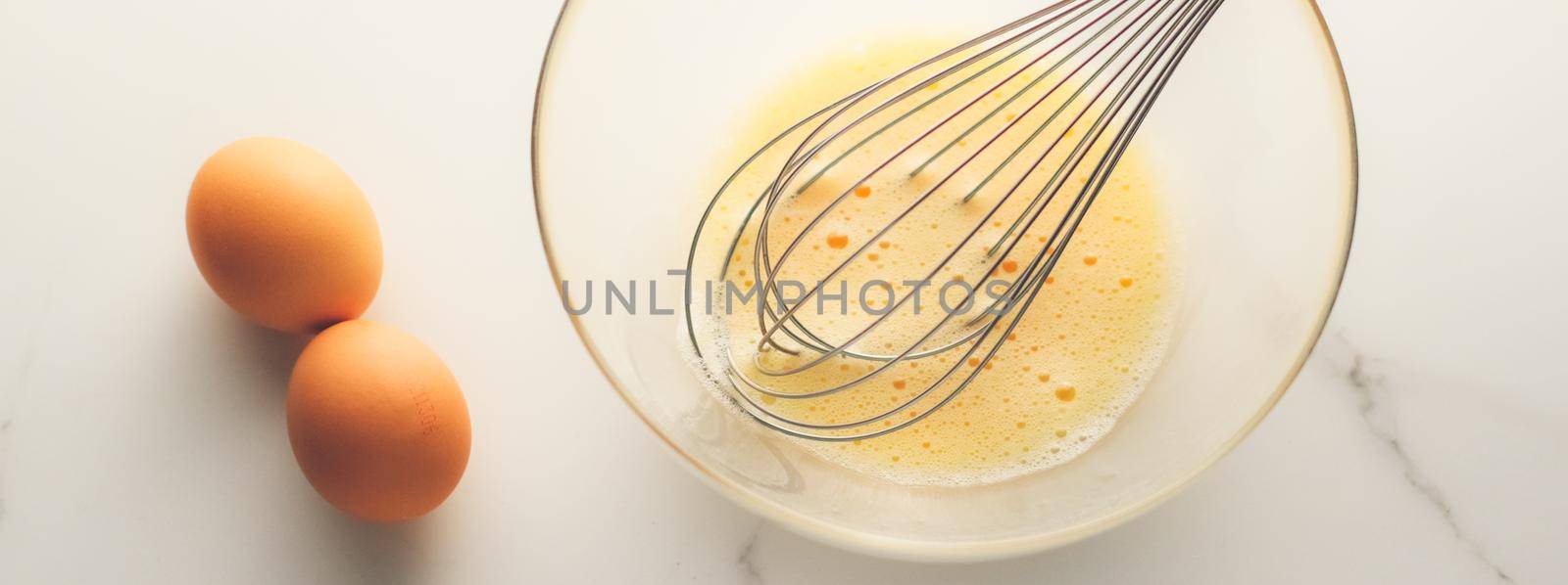 Cooking, meal and diet concept - Making of mixing eggs in bowl on marble table as homemade food flat lay, top view food brand photography flatlay and recipe for cooking blog, menu or cookbook design