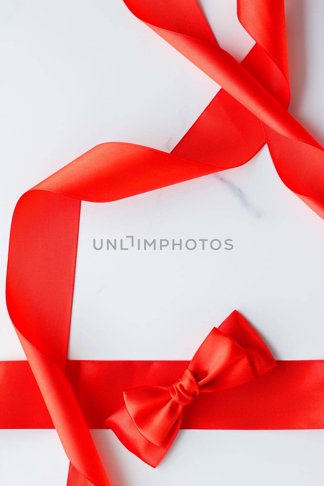 Holiday decor, feminine design and flatlay concept - Red silk ribbon on marble, top view