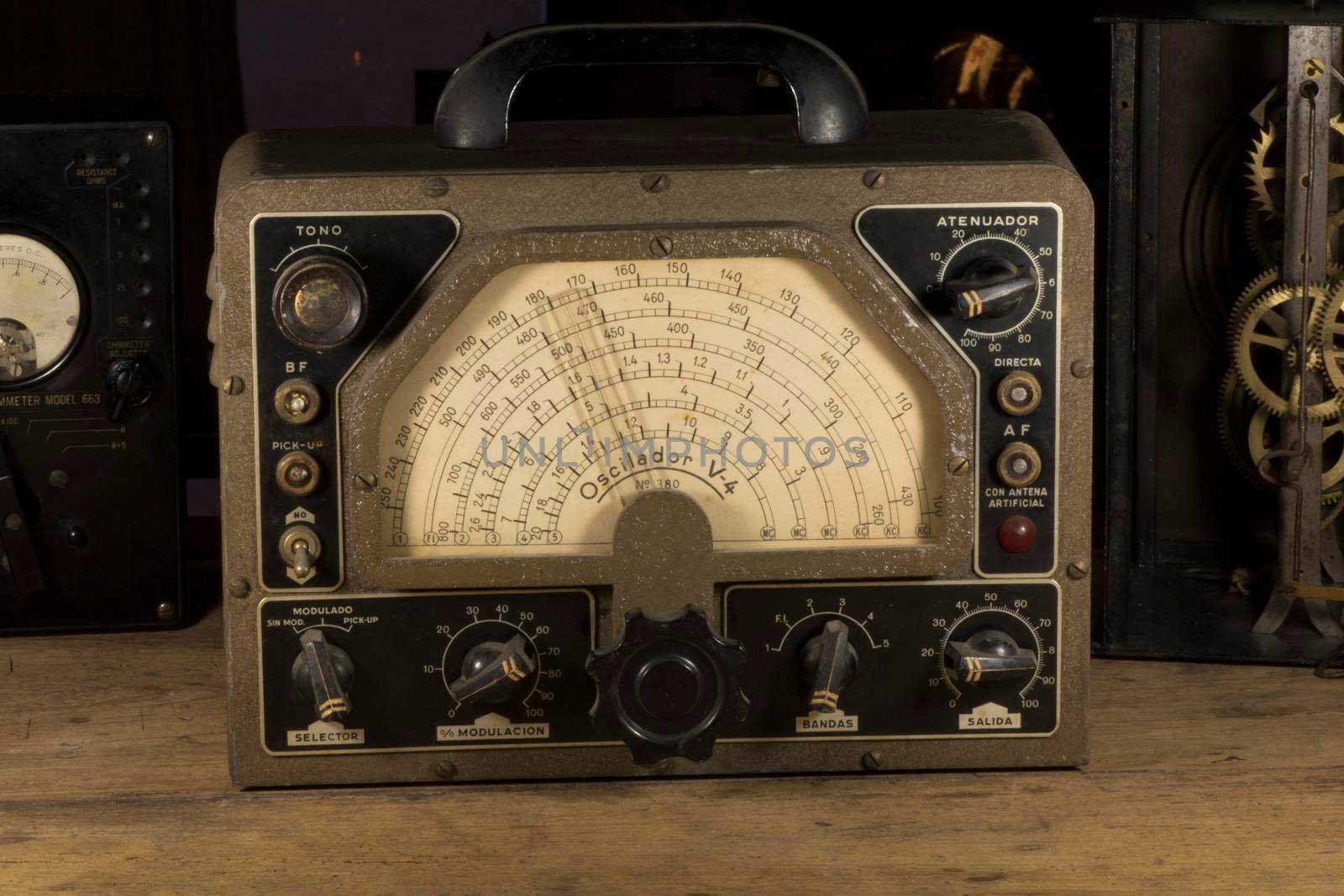 Old electronic gadgets on a wooden table, old technology.