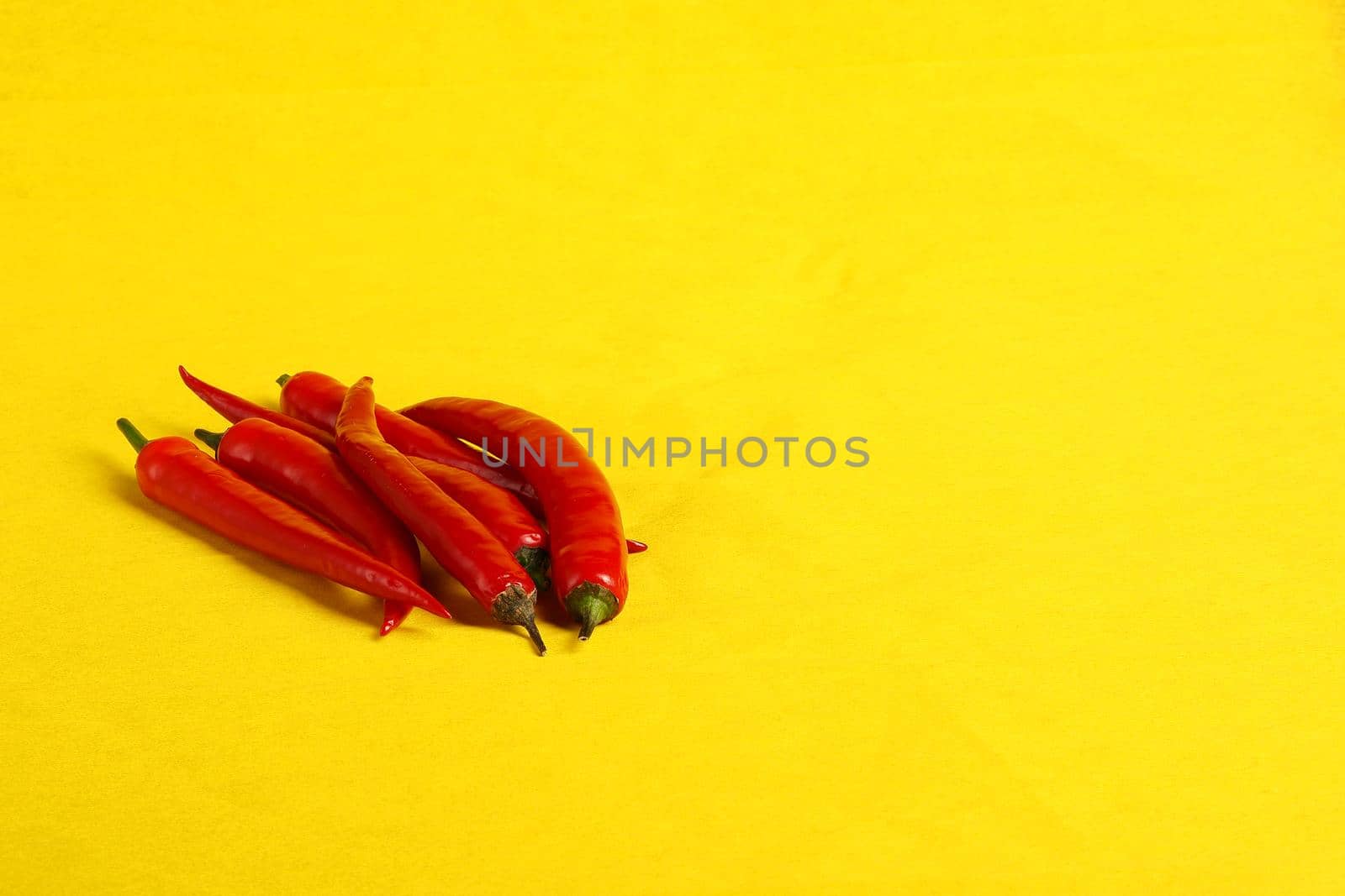 Red pepper pod on a yellow background close-up, isolated, with a place for inscription. High quality photo