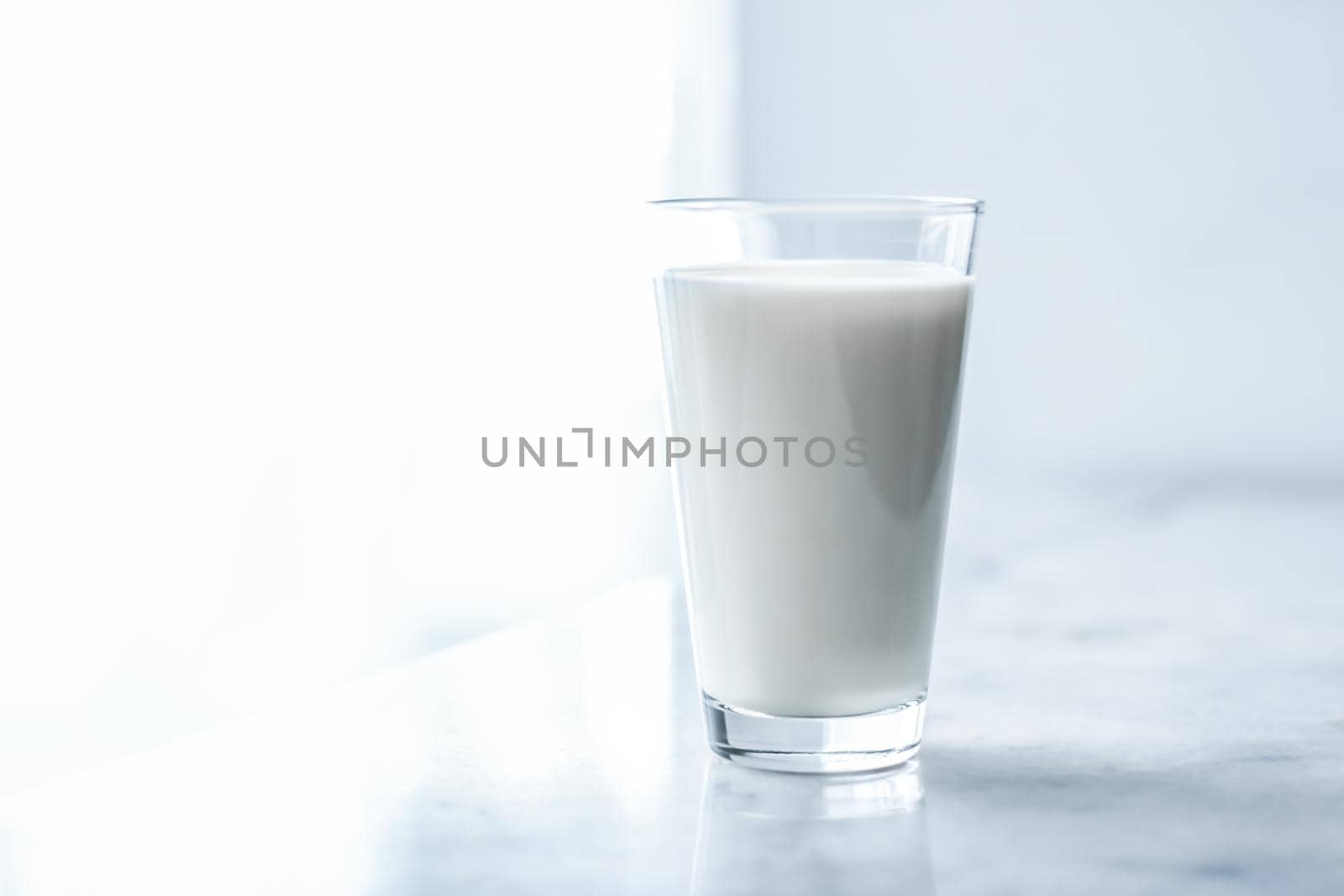 Dairy, healthy nutrition and breakfast concept - World Milk Day, full glass on marble table