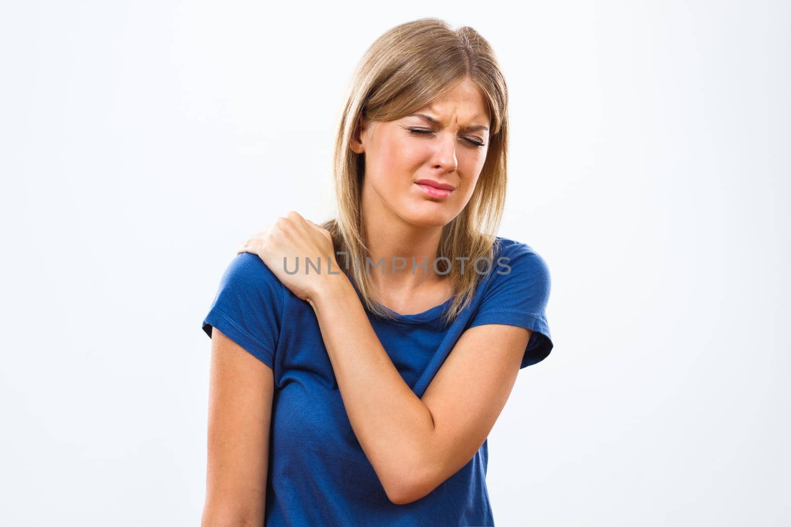 Young woman having shoulder pain isolated on white