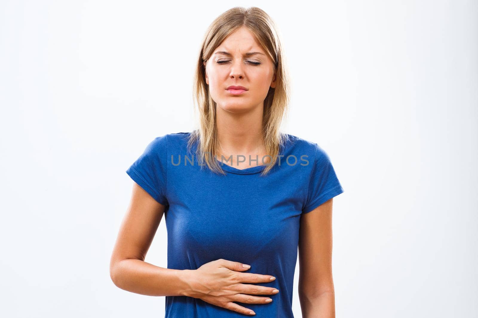 Young woman having stomach pain isolated on white background