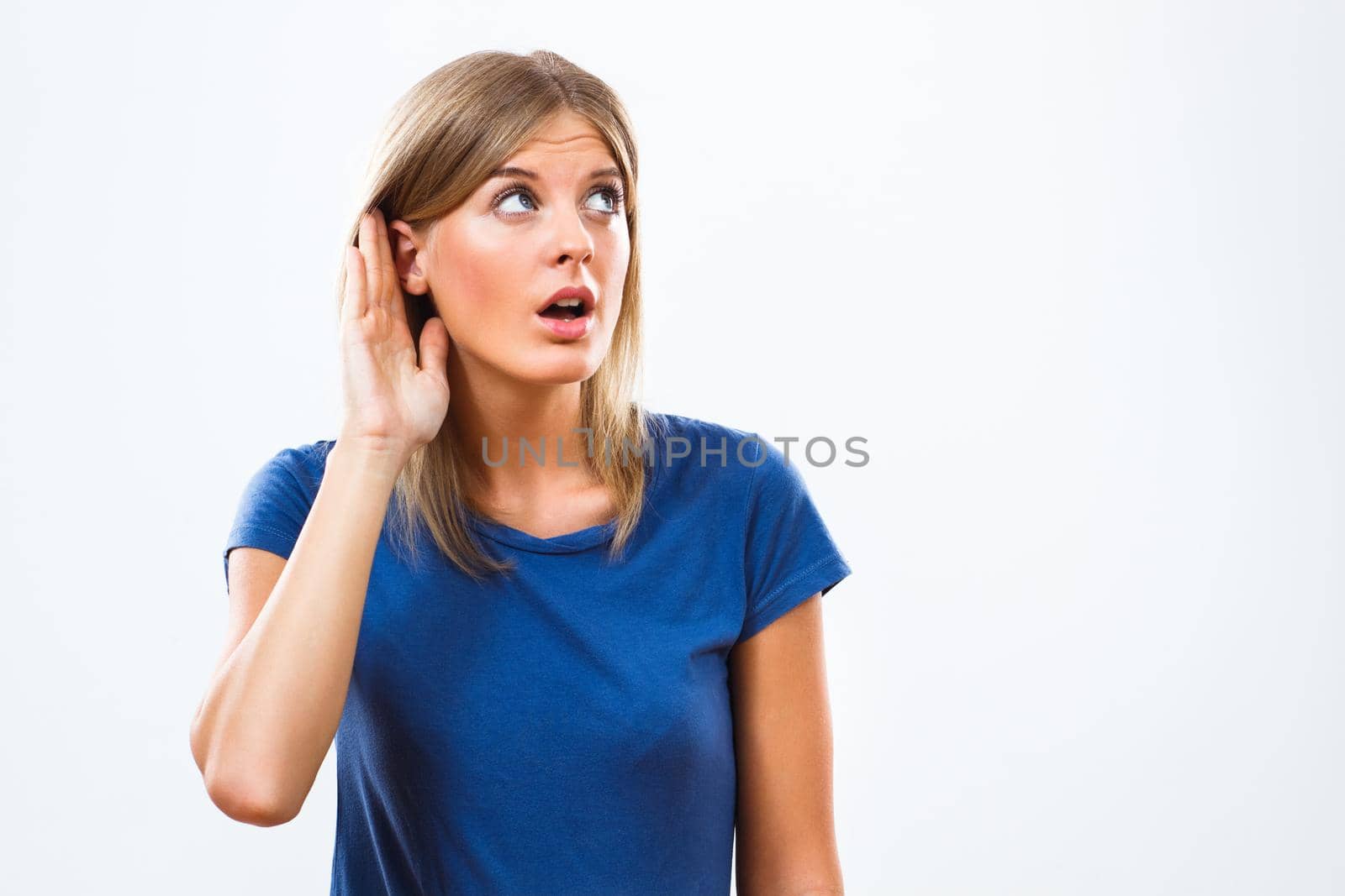 Young woman is listening isolated on white background