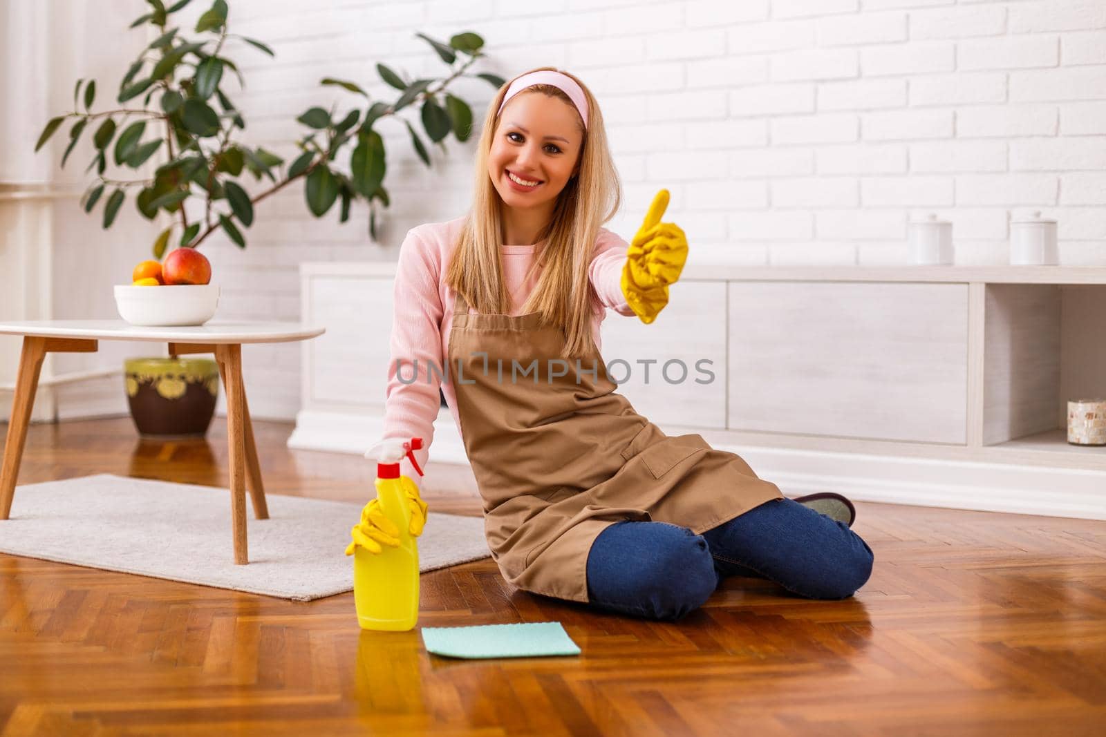 Housewife  cleaning  her home and showing thumb up by Bazdar