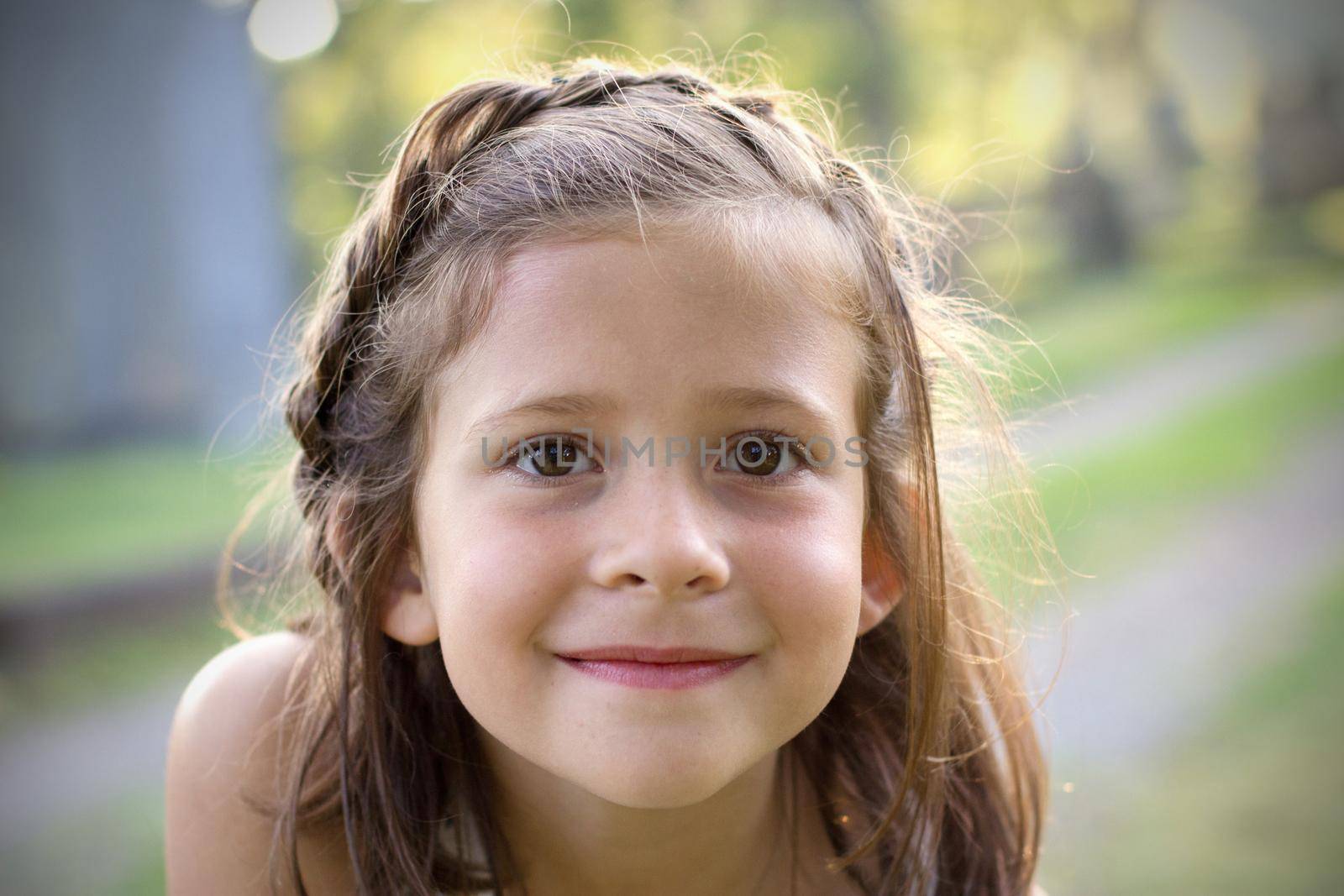 portrait of a beautiful brown eyed girl with braided hair