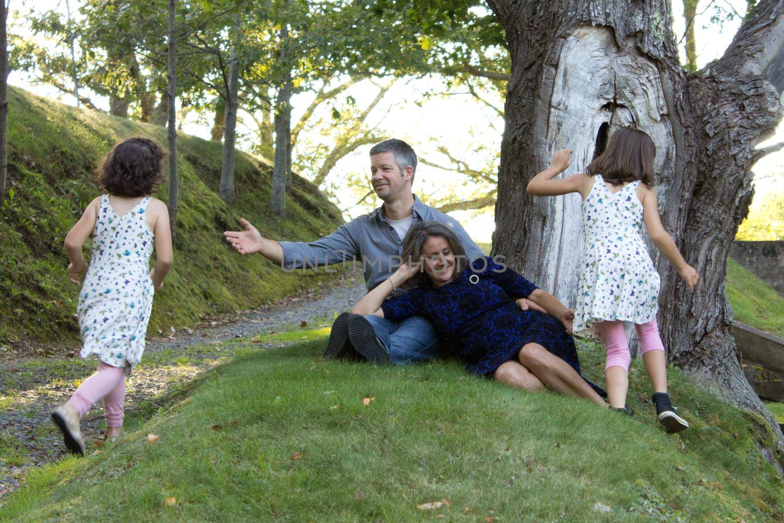  two kids run for their parents who have arms outstretched