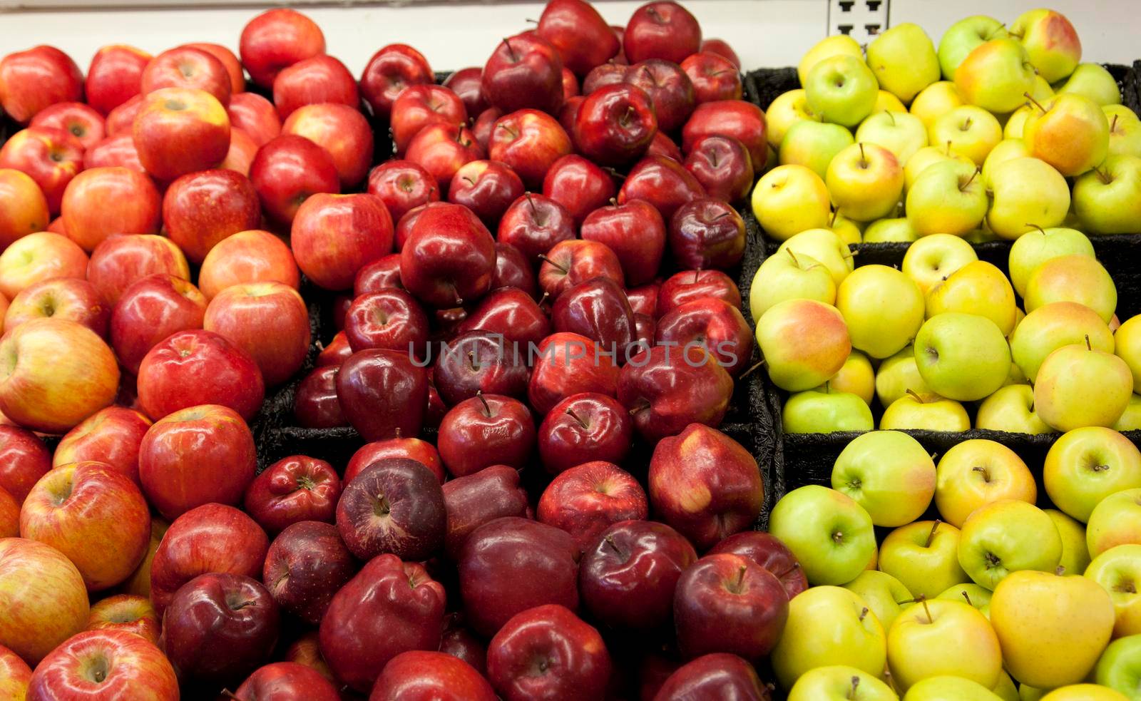 a variety of apple types and shapes at the supermarket