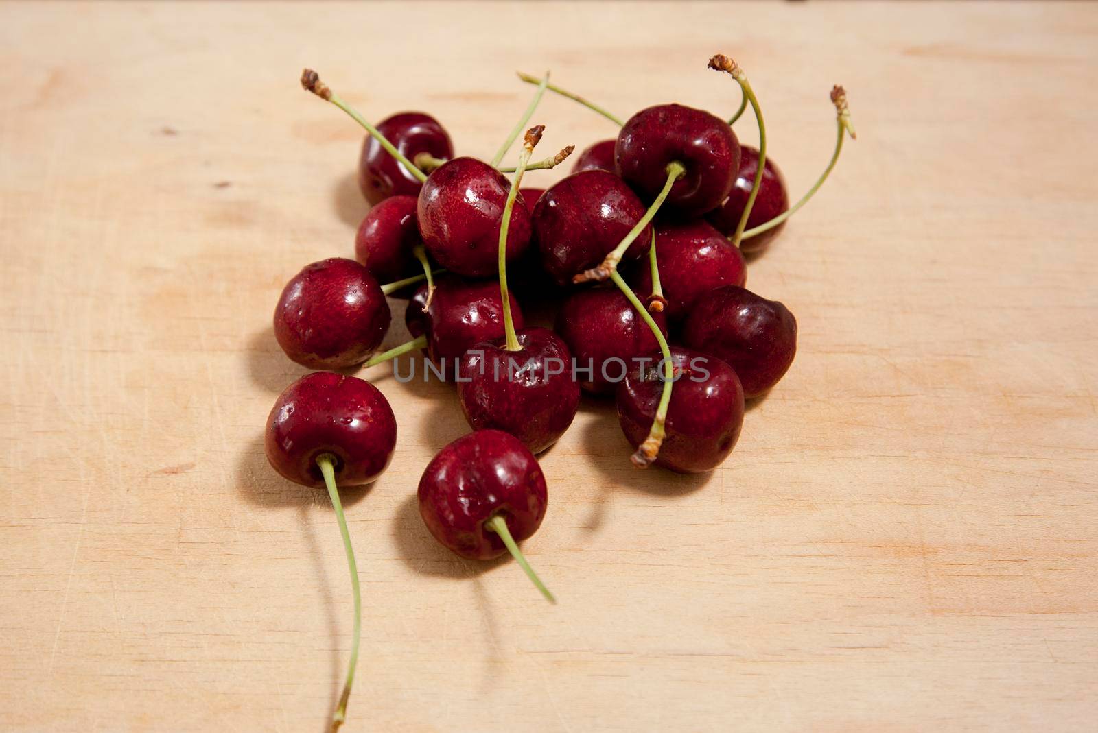  downward view of a group of beautiful red cherries on a wooden board 