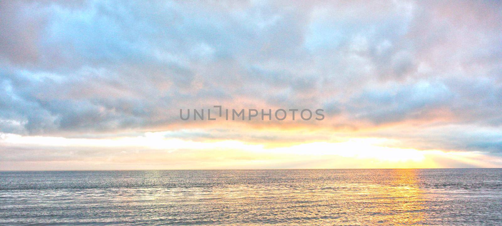 vibrant sunrise sky over ocean by rustycanuck