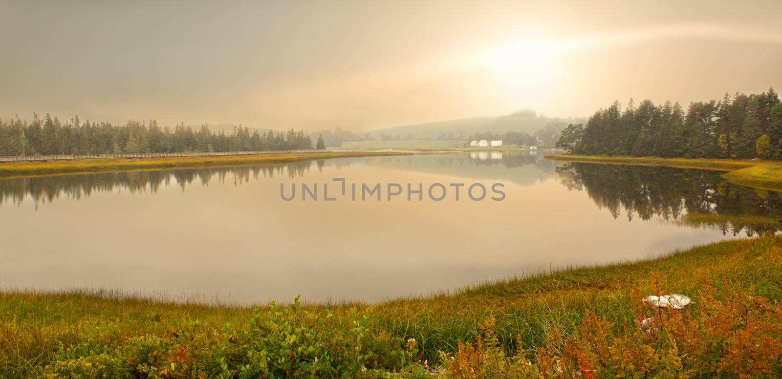 morning over an idyllic lake and hillside by rustycanuck