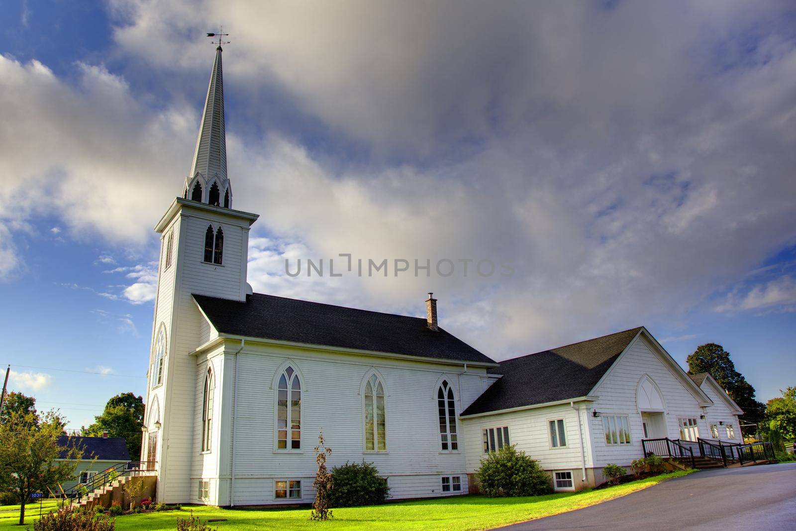 blue sky behind a white church in the spring or summer 