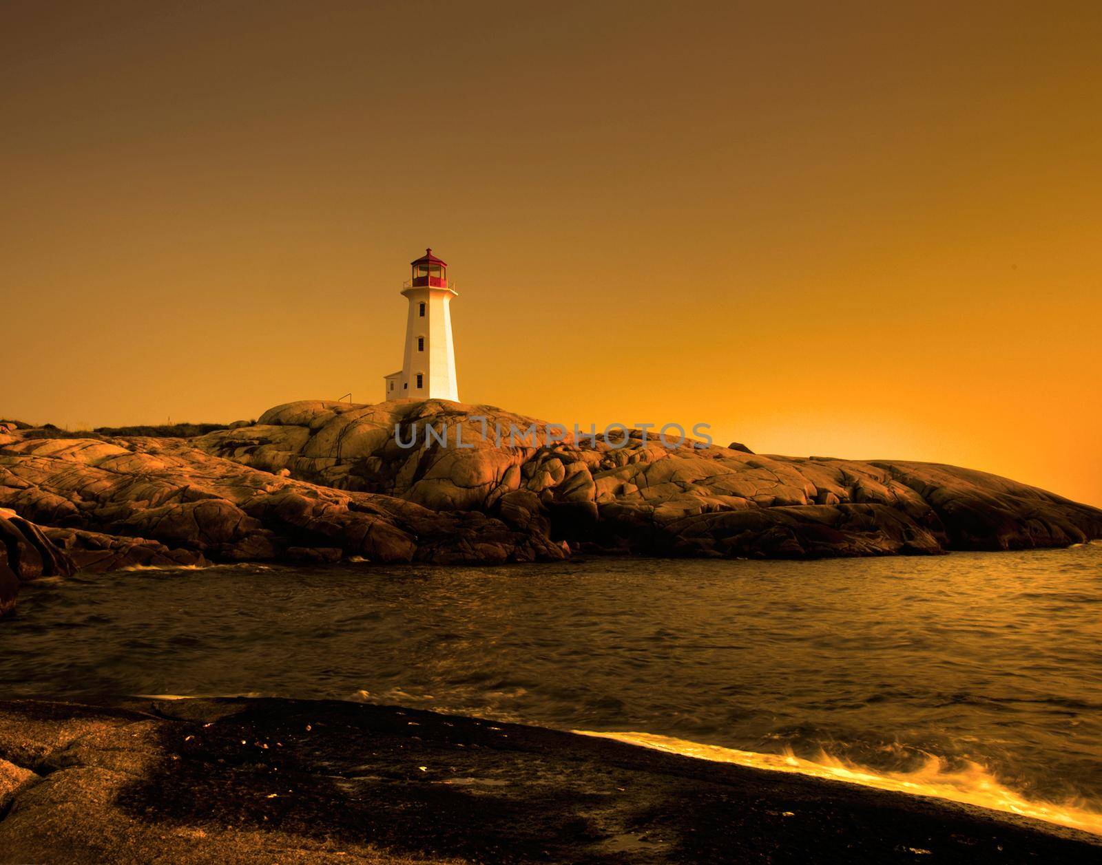 golden sunset view of the famous landmark peggy's cove in nova scotia, canada