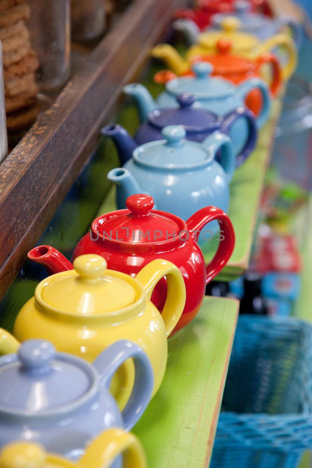 row of tea pots  by rustycanuck