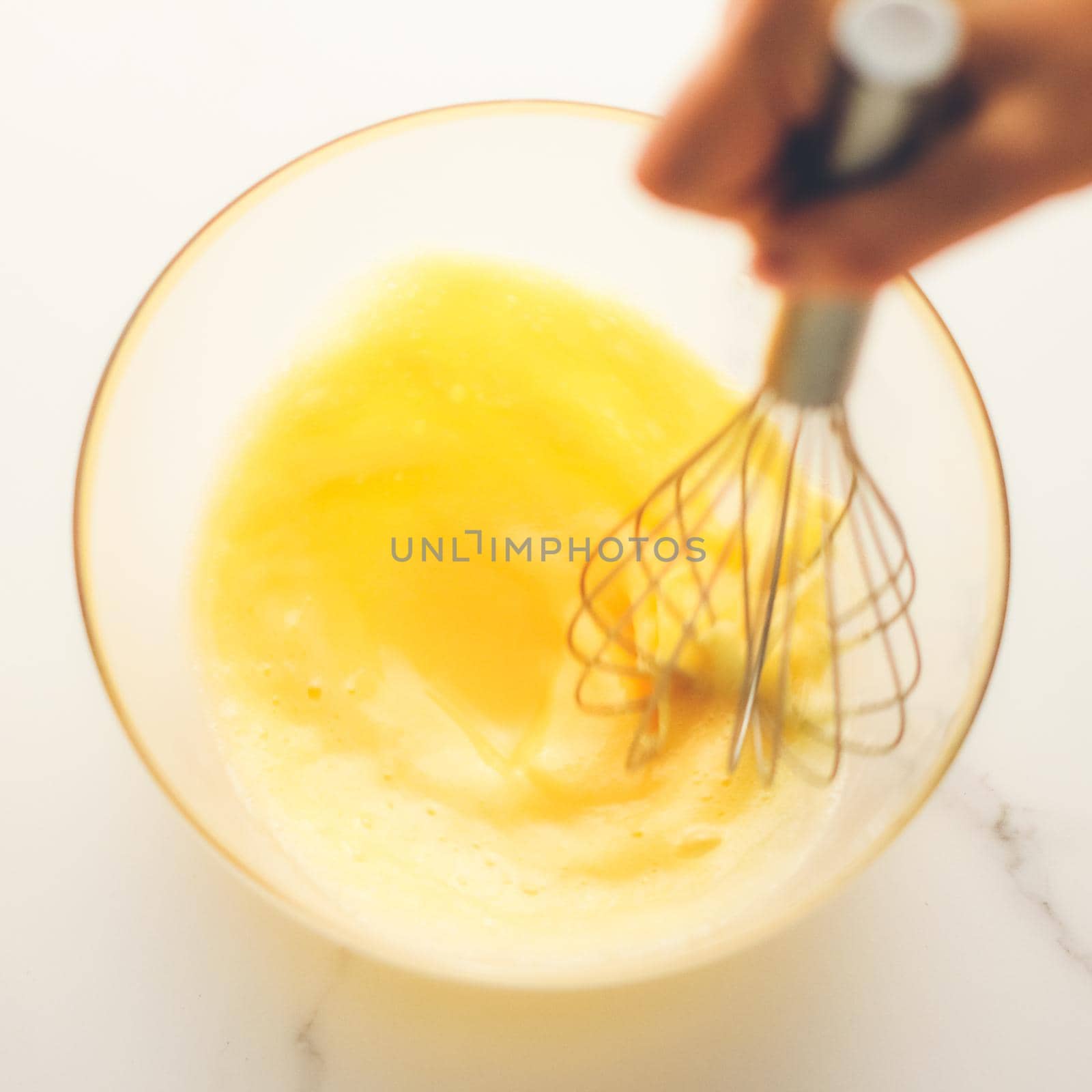 Cooking, meal and diet concept - Making of mixing eggs in bowl on marble table as homemade food flat lay, top view food brand photography flatlay and recipe for cooking blog, menu or cookbook design