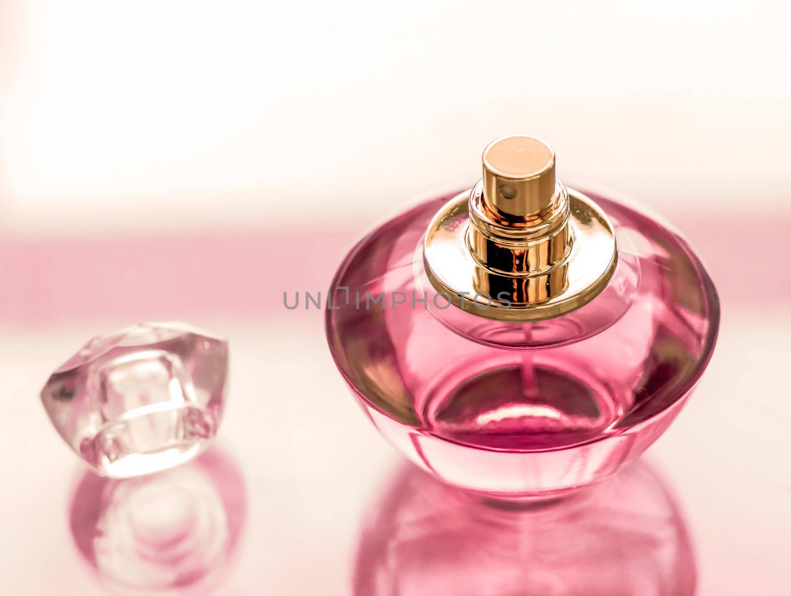 Pink perfume bottle on glossy background, sweet floral scent, glamour fragrance and eau de parfum as holiday gift and luxury beauty cosmetics brand design by Anneleven