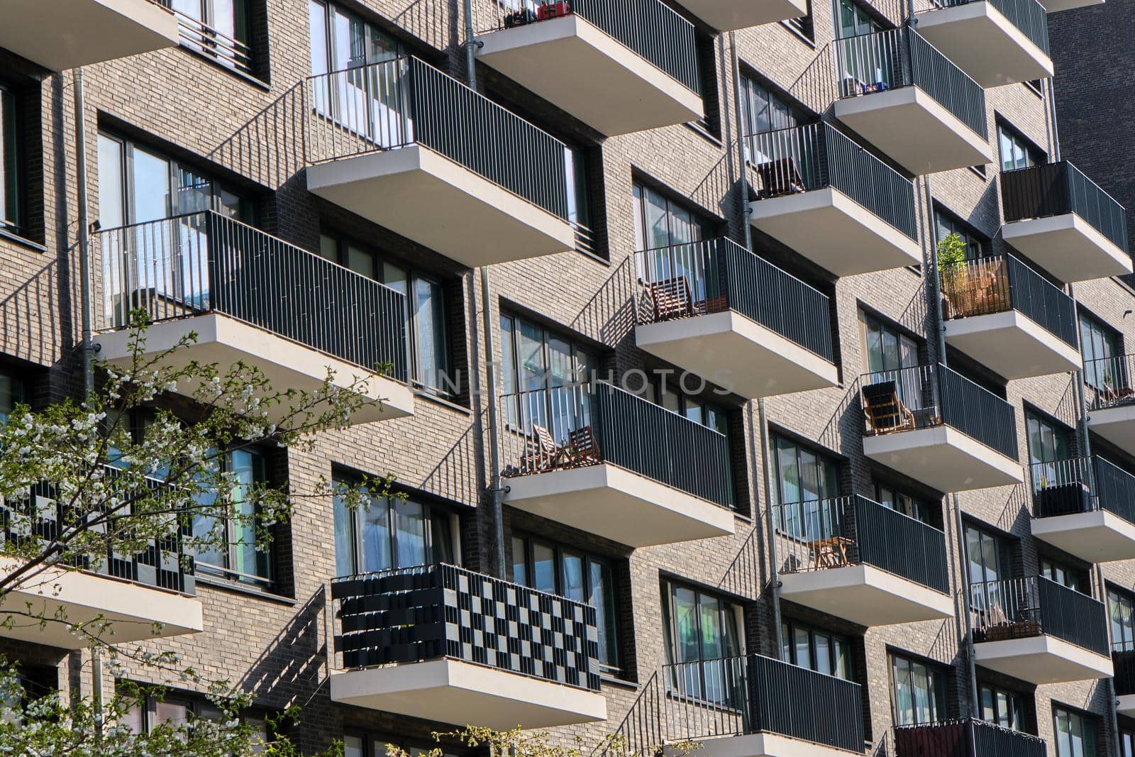 Detail of the facade of a modern apartment building with many balconies