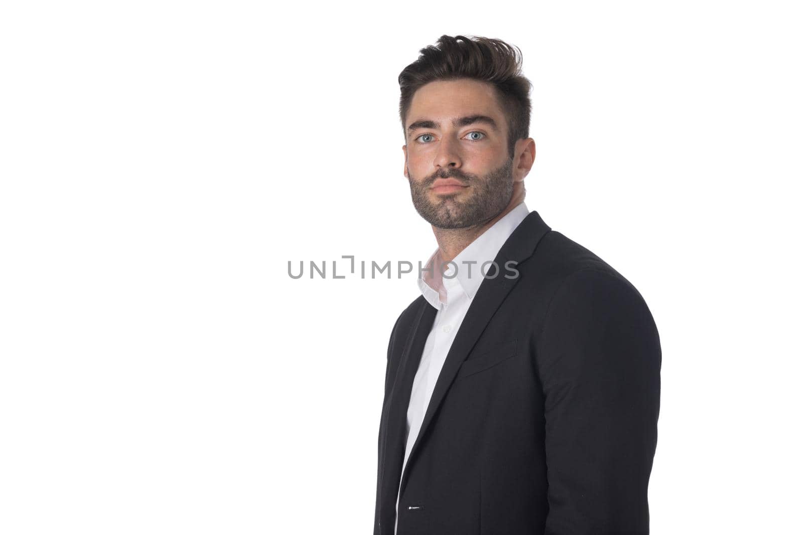 Portrait of young handsome business man in black suit studio isolated on white background