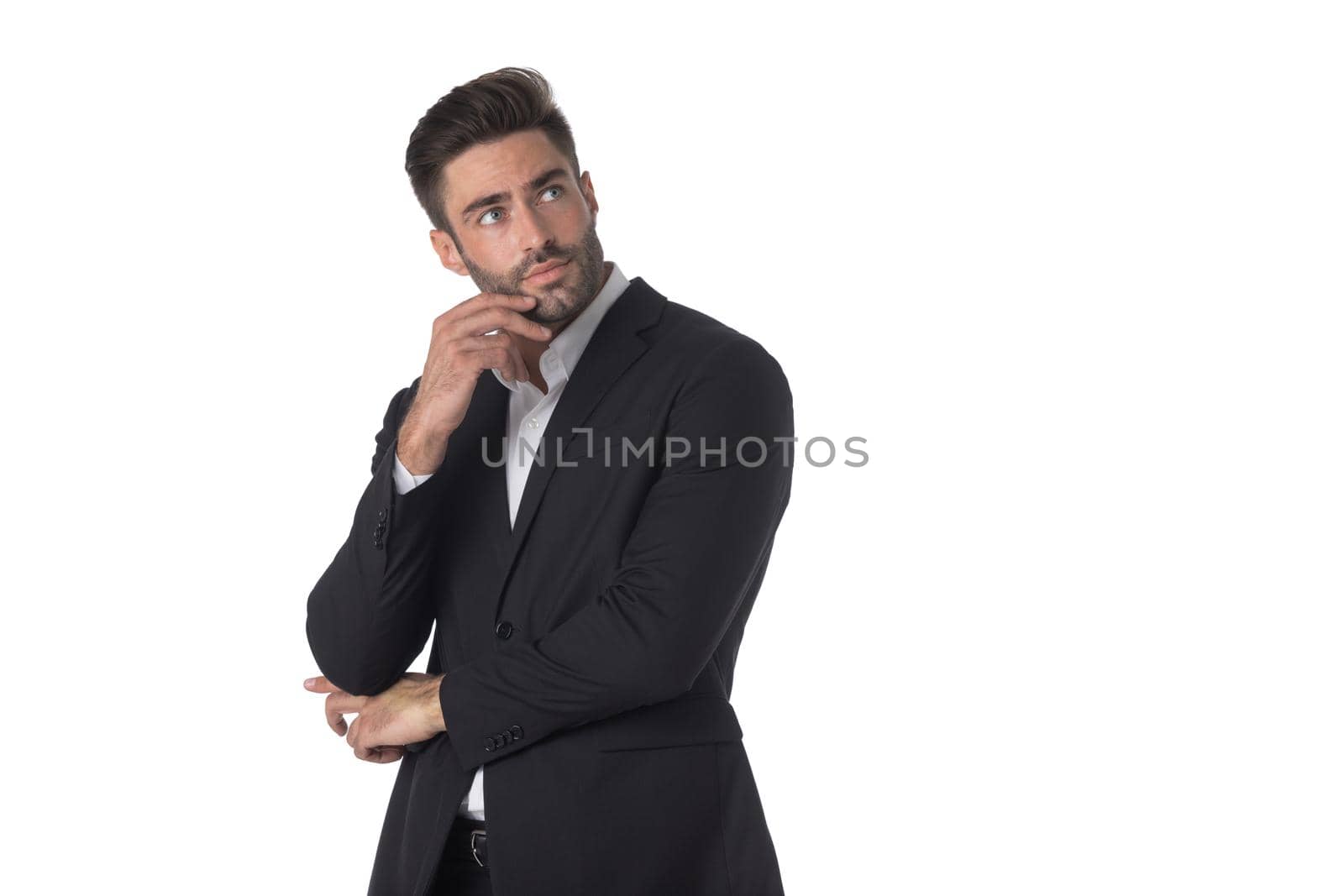 Portrait of young handsome business man in black suit thinking holding hand on chin studio isolated on white background