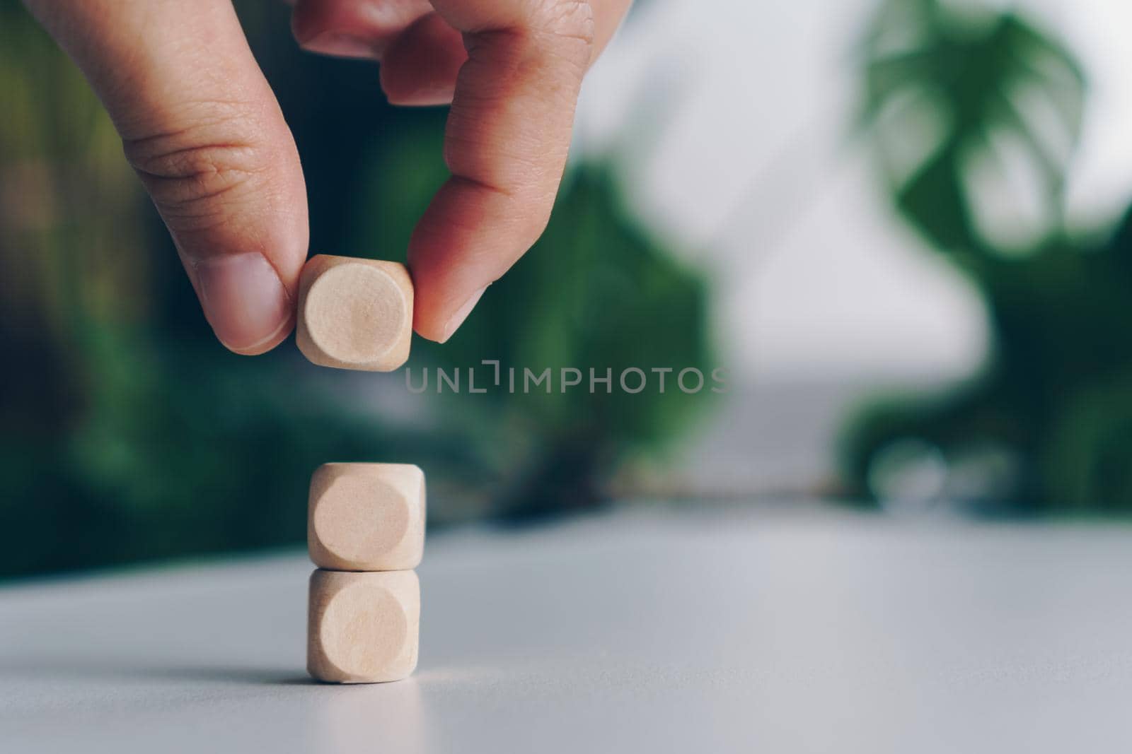 Blank wooden cube that you can put text or icon on in hand hold background. 