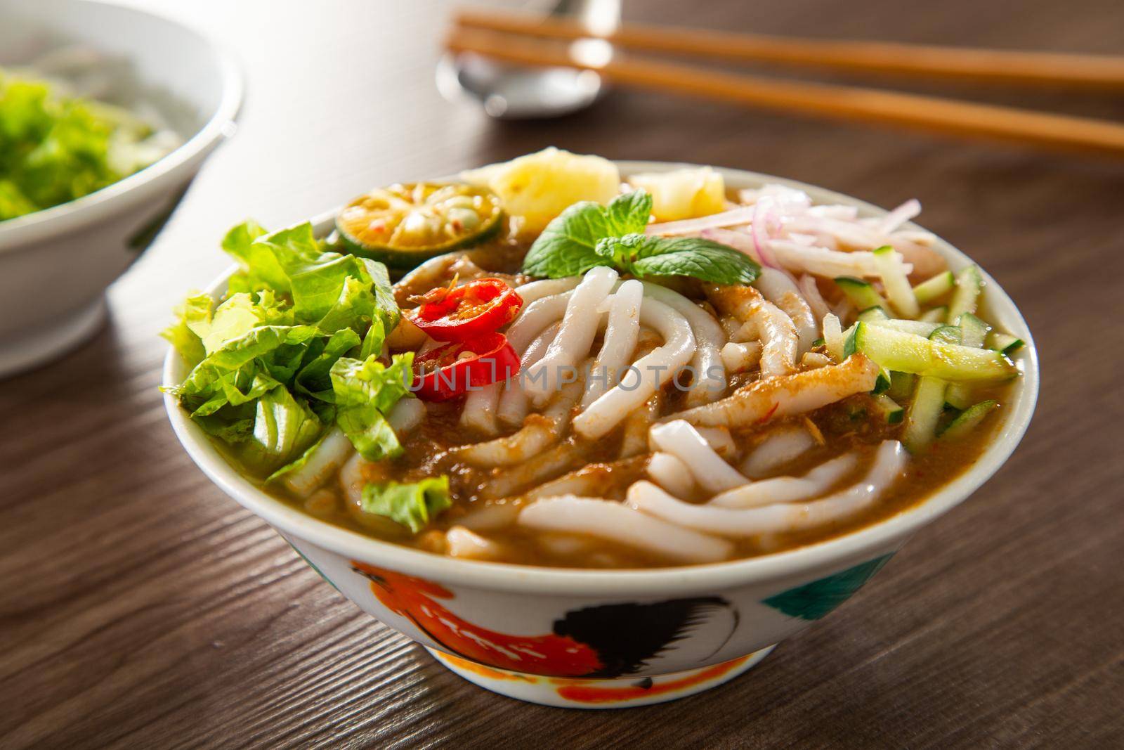 Assam Laksa (Noddle in Tangy Fish Gravy) is a Special Malaysian Food Popular in Penang by tehcheesiong