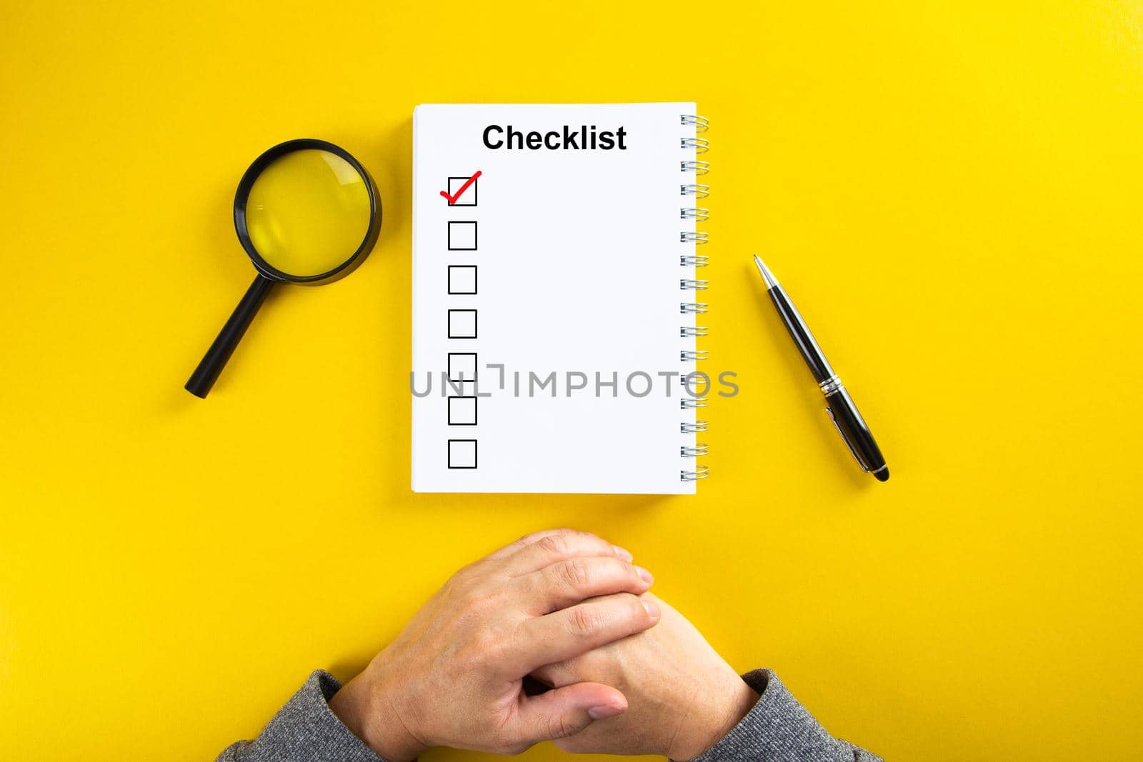 Notebook with Checklist. Flat lay concept. On yellow background