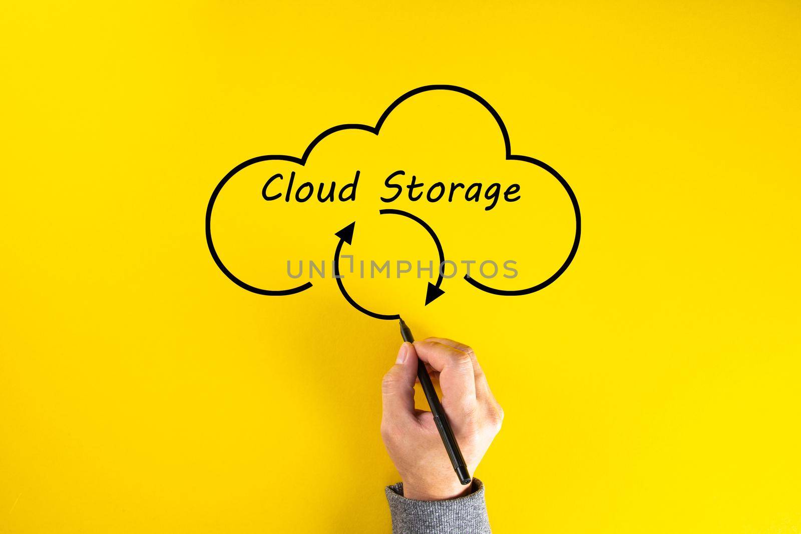 Human hand drawing cloud storage on yellow background. Data storage, Networking and internet service concept.