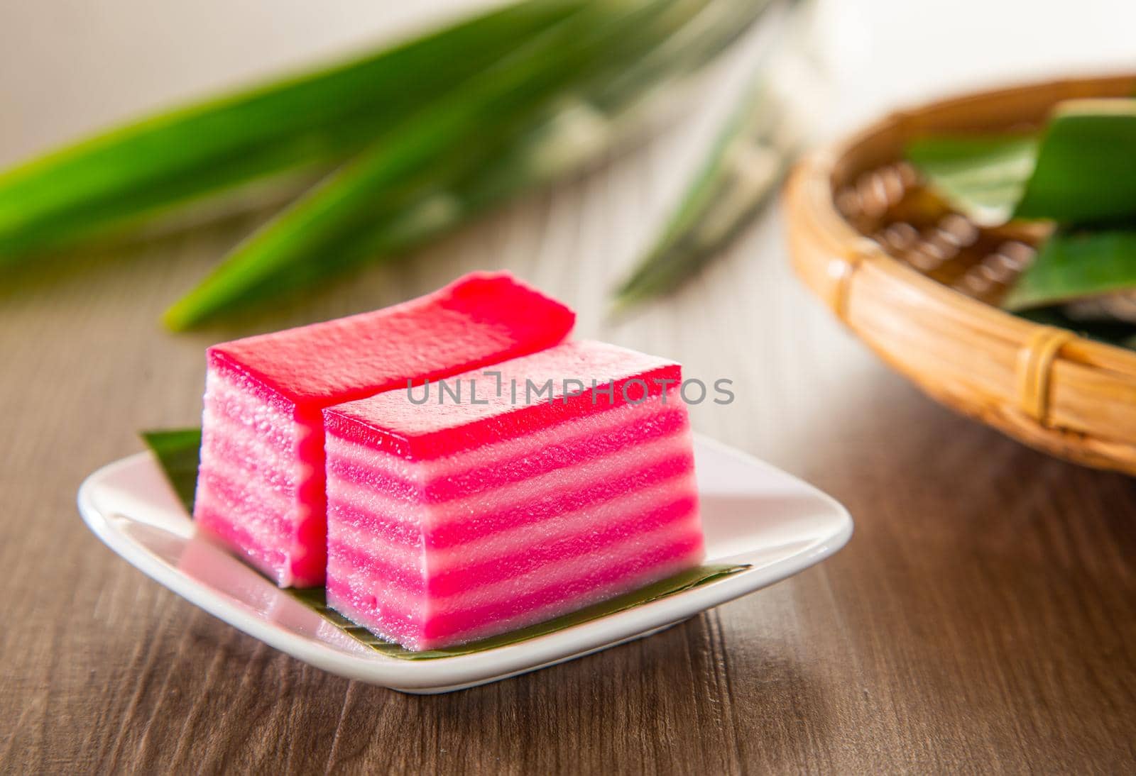 Kuih lapis is a traditional Malay nyonya sweet desert on wooden table by tehcheesiong