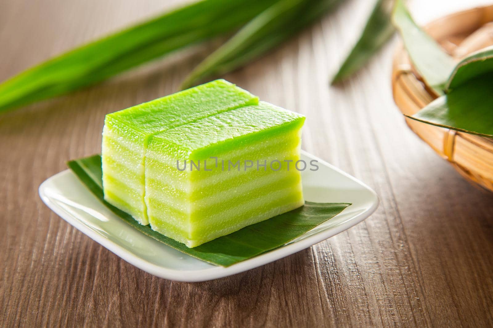 Kuih lapis is a traditional Malay nyonya sweet desert on wooden table by tehcheesiong