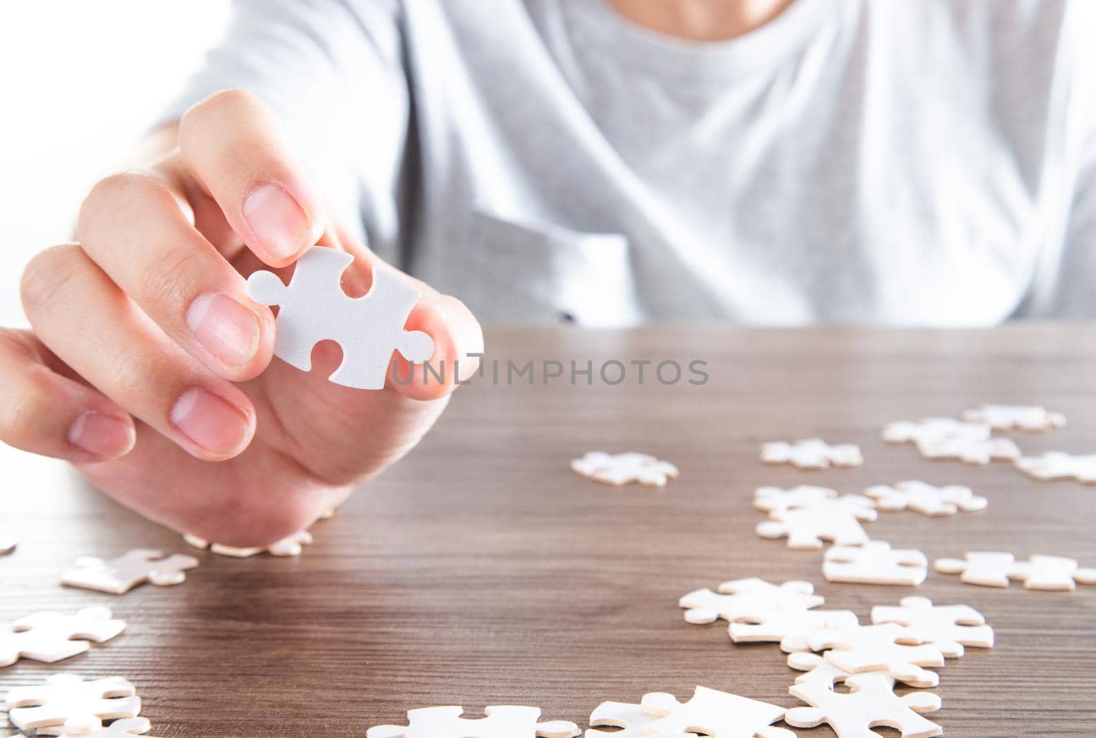 Closeup hand of man holding parts jigsaw puzzle. Business solutions, success and strategy concept