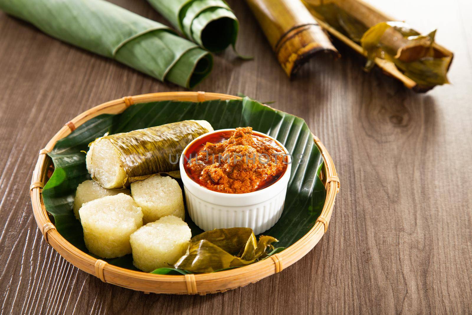 Glutinous rice is wrapped with lerek or banana leaf encased in bamboo culm and cooked in open fire / Lemang / A must have in every traditional Malay household, eaten with beef or chicken rendang by tehcheesiong