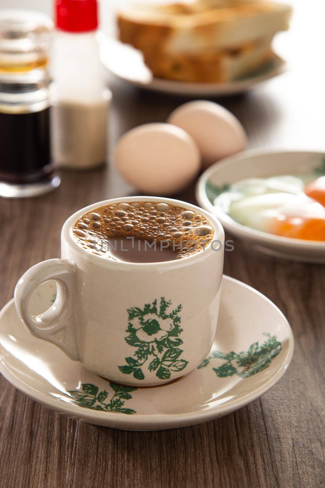 Common oriental breakfast set in Malaysia consisting of coffee, nasi lemak, toast bread and half-boiled egg