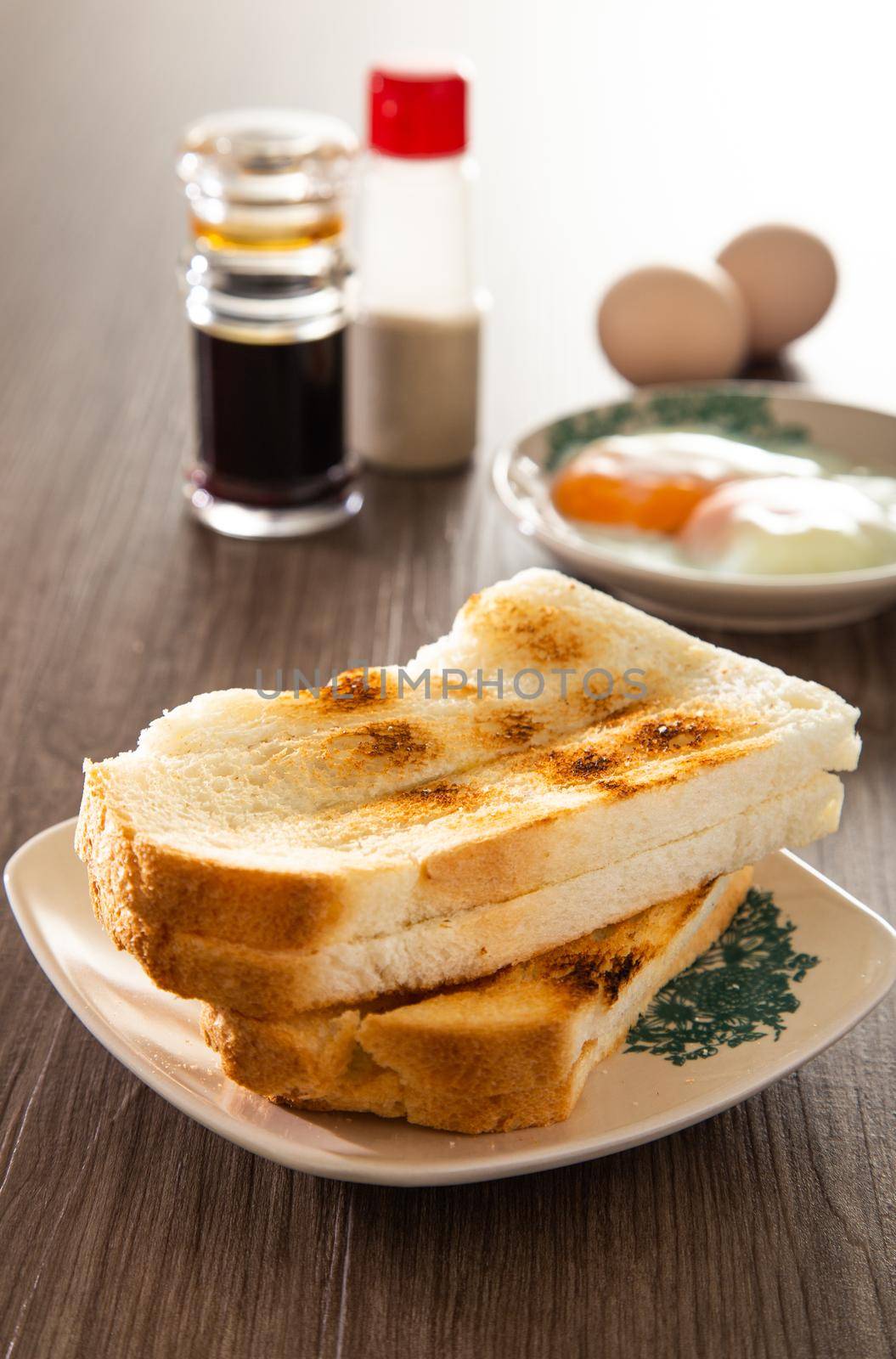 Oriental breakfast set in Malaysia consisting of coffee, nasi lemak, toast bread and half-boiled egg by tehcheesiong