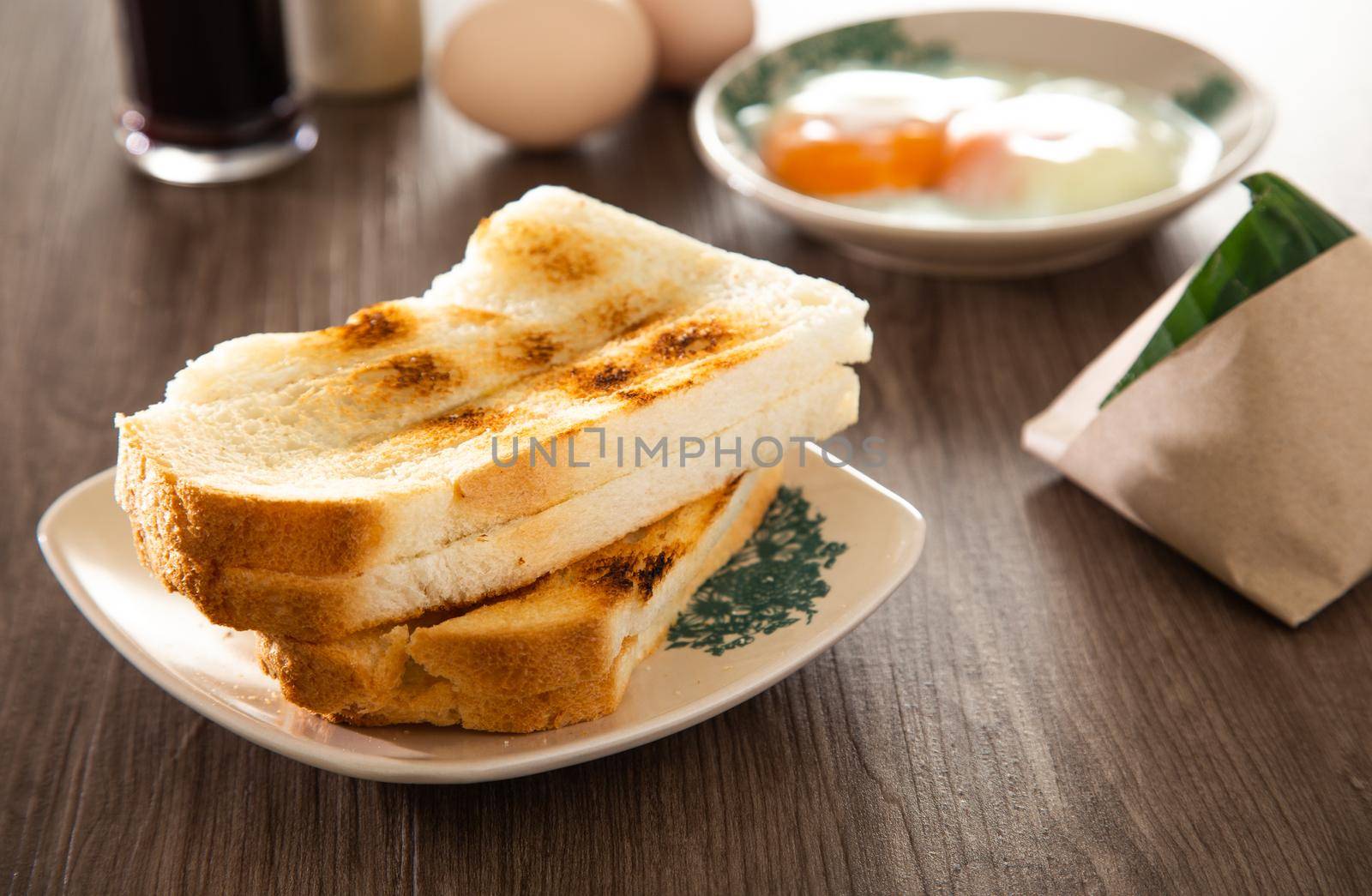 Common oriental breakfast set in Malaysia consisting of coffee, nasi lemak, toast bread and half-boiled egg