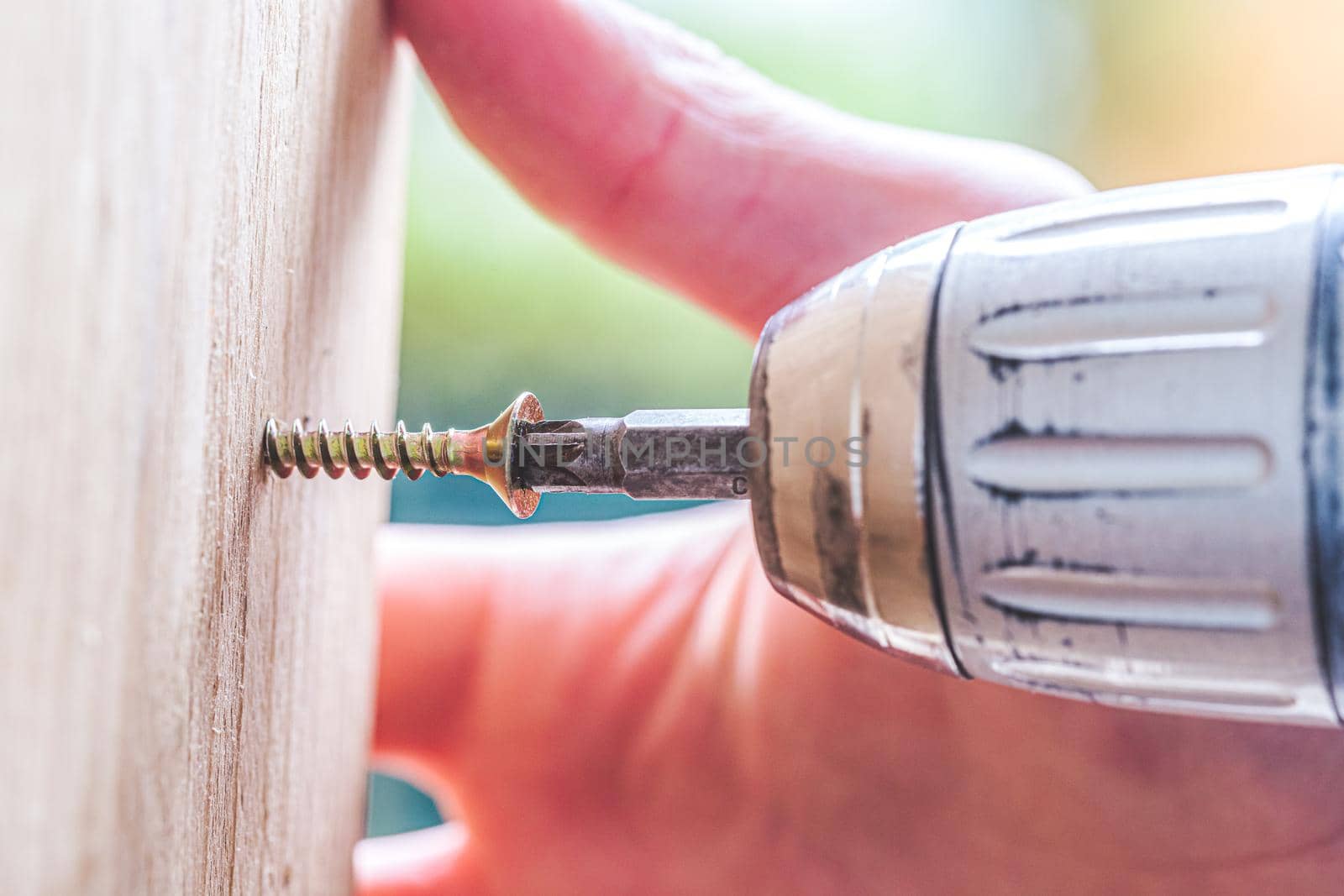 Close up of screw and screwing machine, workshop