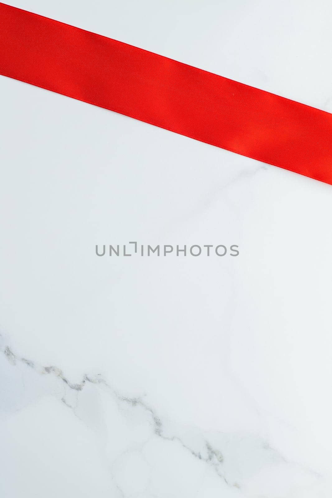 Holiday decor, feminine design and flatlay concept - Red silk ribbon on marble, top view