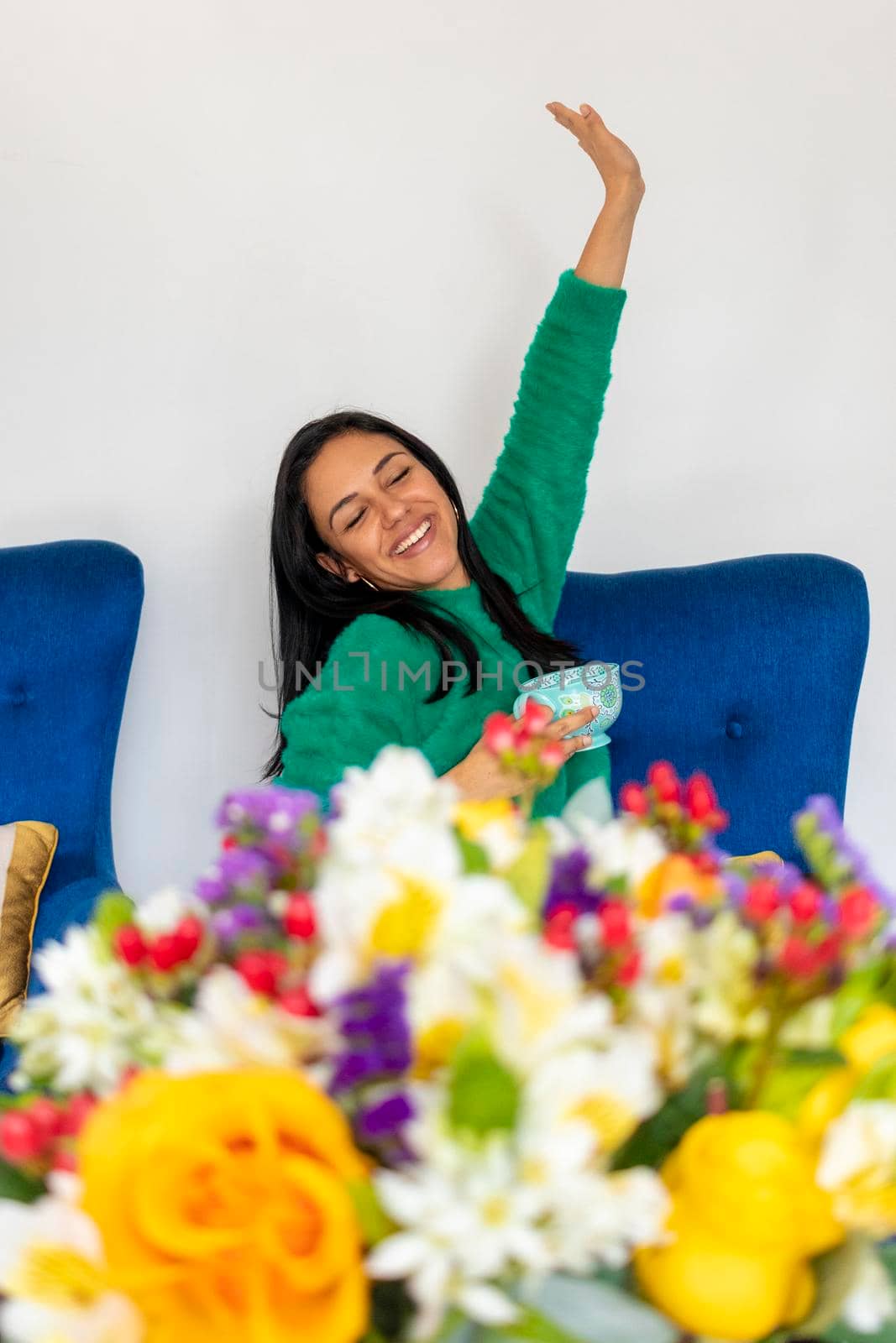 Happy beautiful young woman with her flower arrangement in your home by eagg13