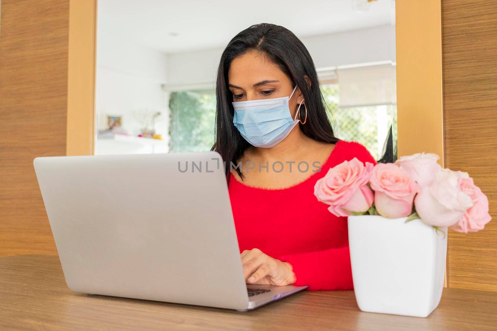 Beauty hispanic woman is working at home