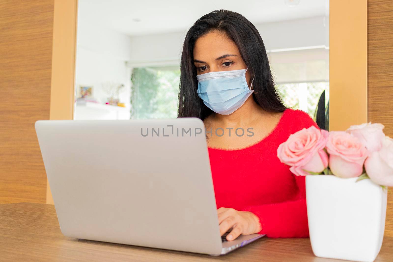 Beauty hispanic woman is working at home