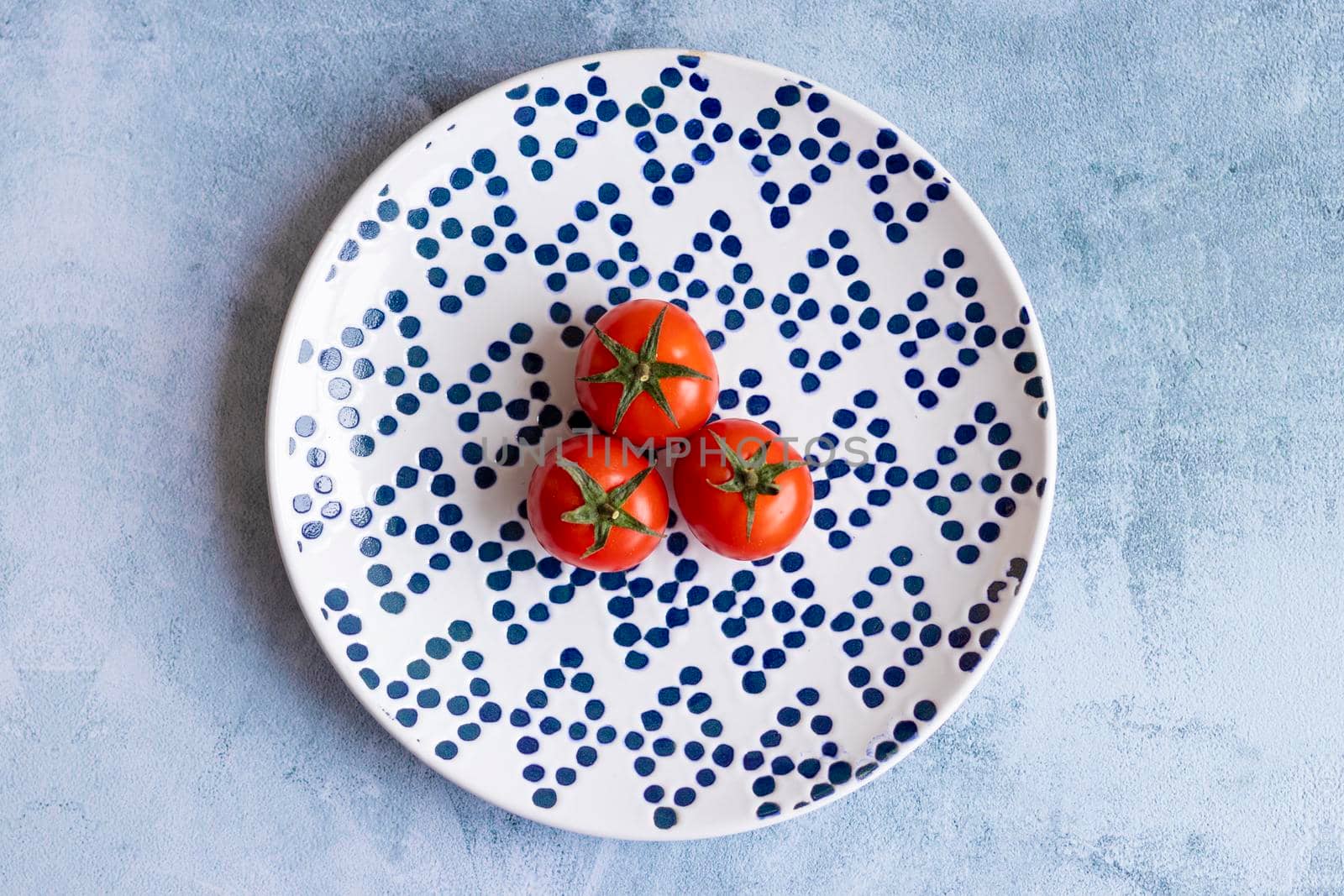 Cherry tomatoes on blue dotted plate