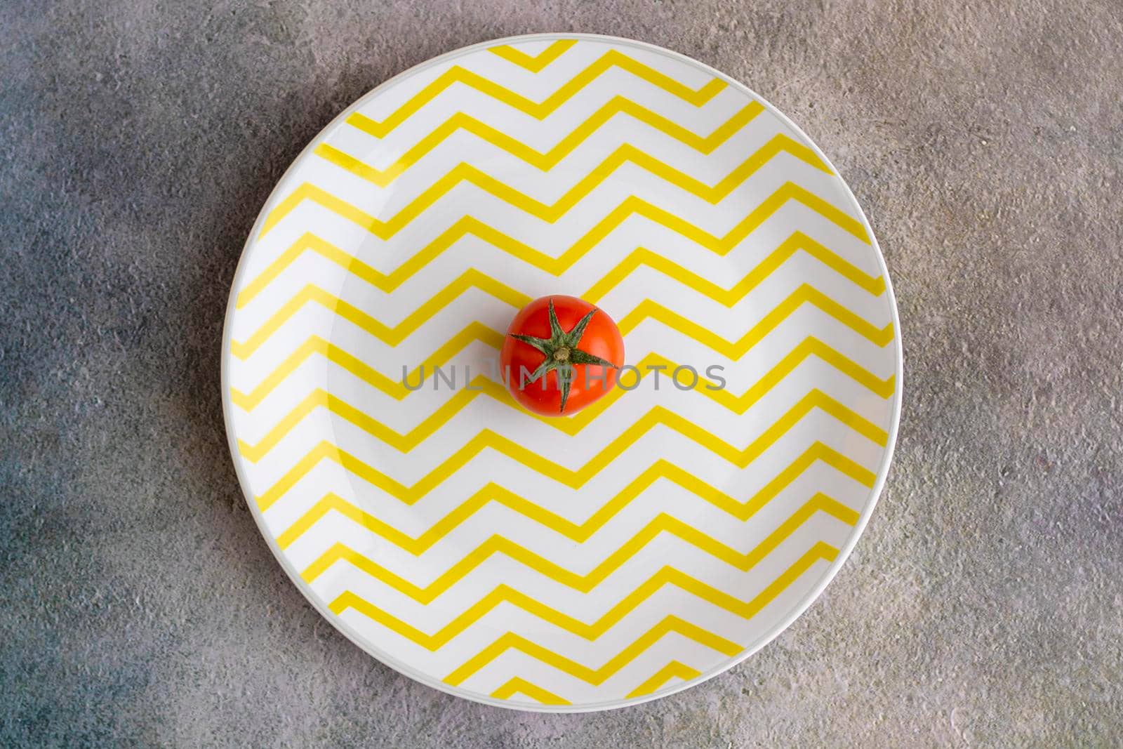 Cherry tomatoes on yellow striped plate by eagg13