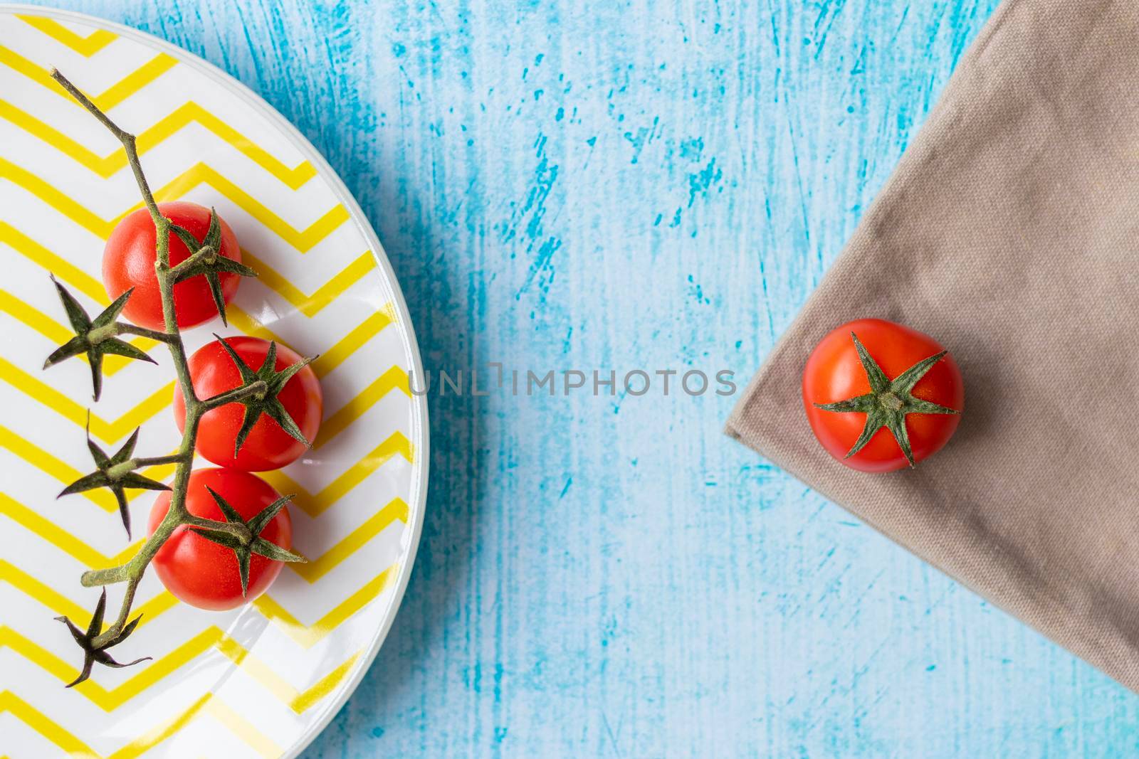 Cherry tomatoes on yellow striped plate by eagg13
