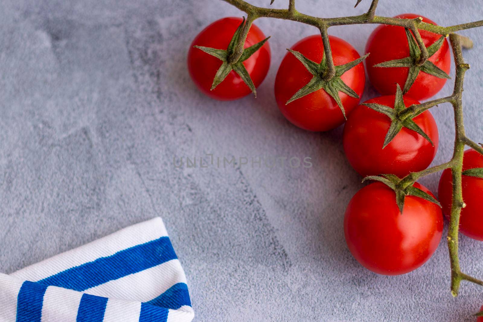 Cherry tomatoes on blue brushstroke background by eagg13