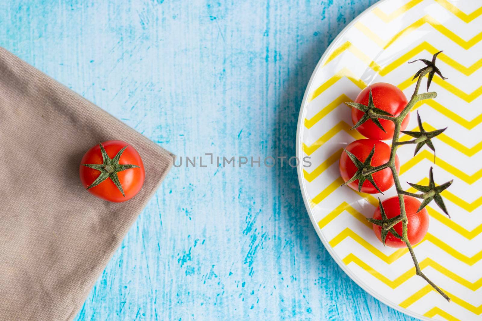 Cherry tomatoes on yellow striped plate by eagg13