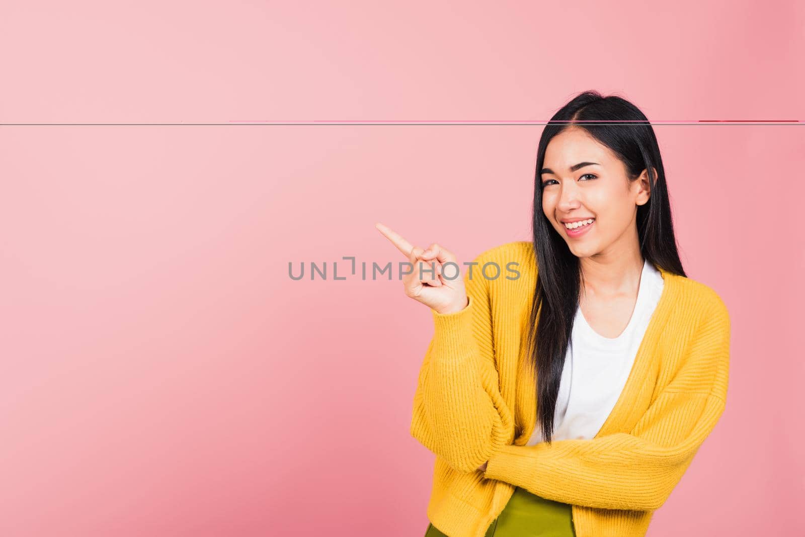 woman standing pointing finger side away presenting product by Sorapop